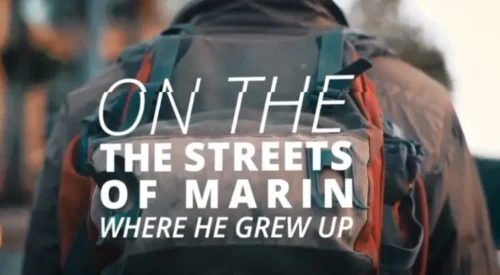 a man wearing a backpack with overlaying text, "on the streets of Marin. where he grew up."