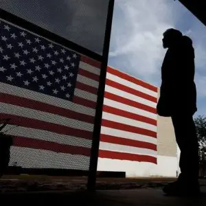 Veteran stands by flag