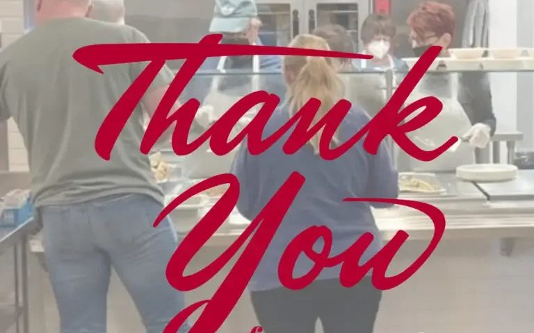 people being served in a cafeteria kitchen with the words 'Thank You'