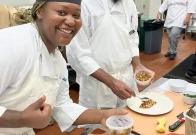 A student chef showing off what she's making.