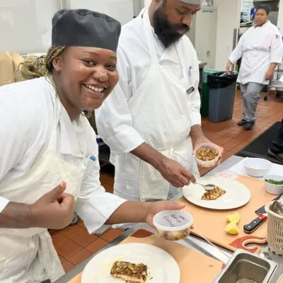 A student chef showing off what she's making.