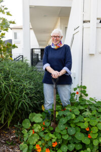 Volunteer Linda stands in a garden