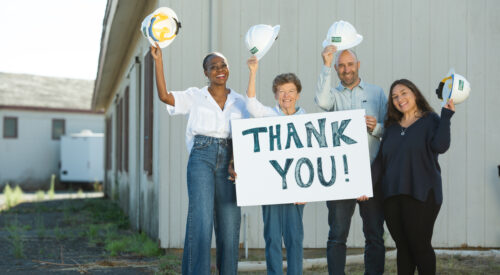 LaLaSaunda Tate, Mary Kay Sweeney, Paul Fordham and Anna Hurtado hold up a sign that says thank you