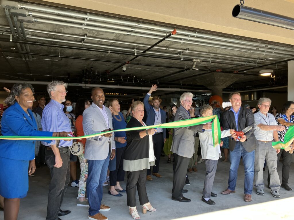 a group participating in a ribbon cutting ceremony