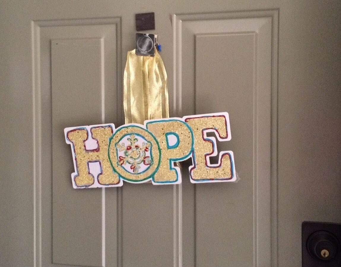A sign that says hope hanging on a door