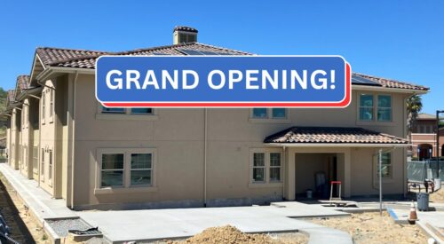 Photo shows the entry to the veterans housing with a banner that says "Grand Opening"