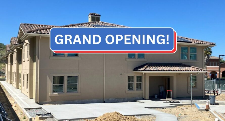 Photo shows the entry to the veterans housing with a banner that says "Grand Opening"