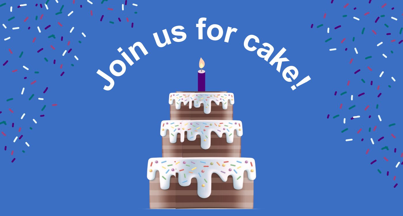 Image with blue background shows tall chocolate layer cake with white frosting and sprinkles.