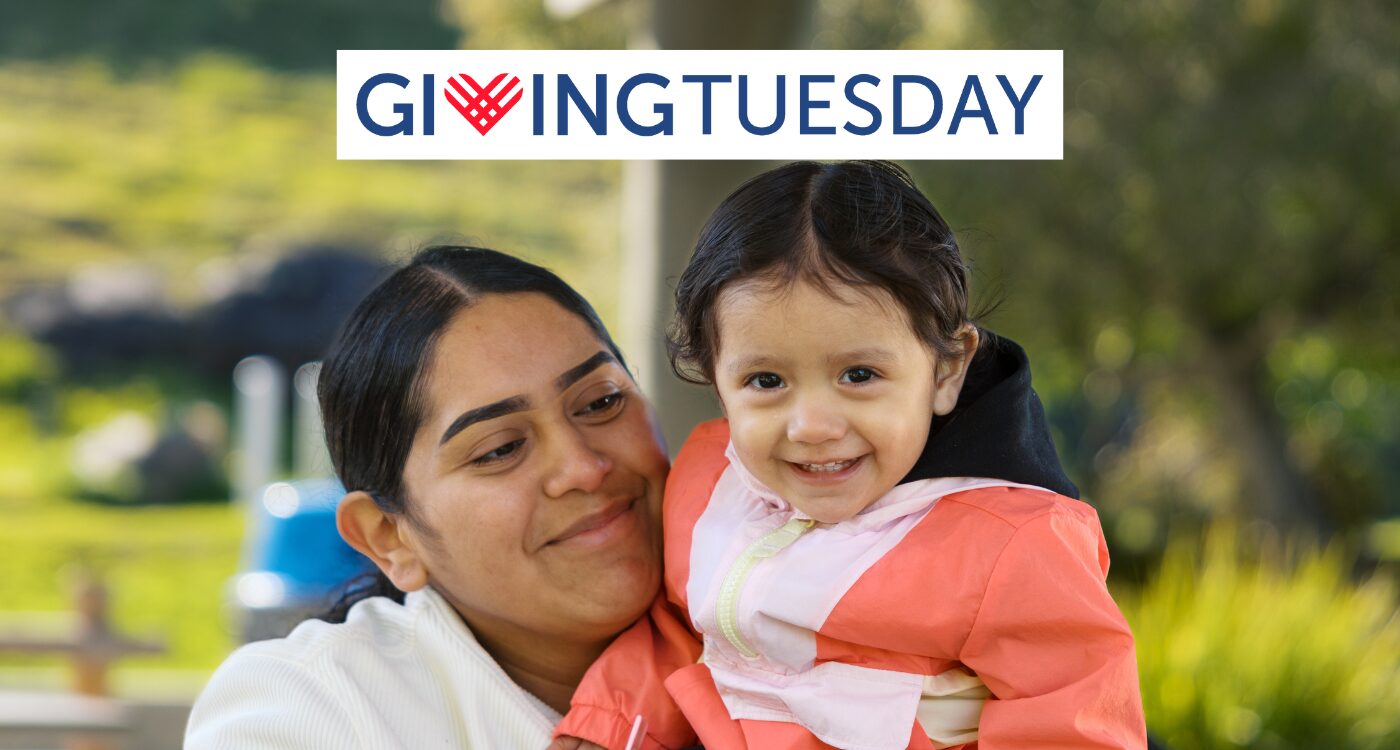 Smiling mother and child with Giving Tuesday logotype at top of image
