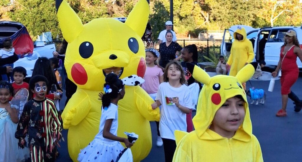 Group of kids in Halloween costumes that include Pikachu